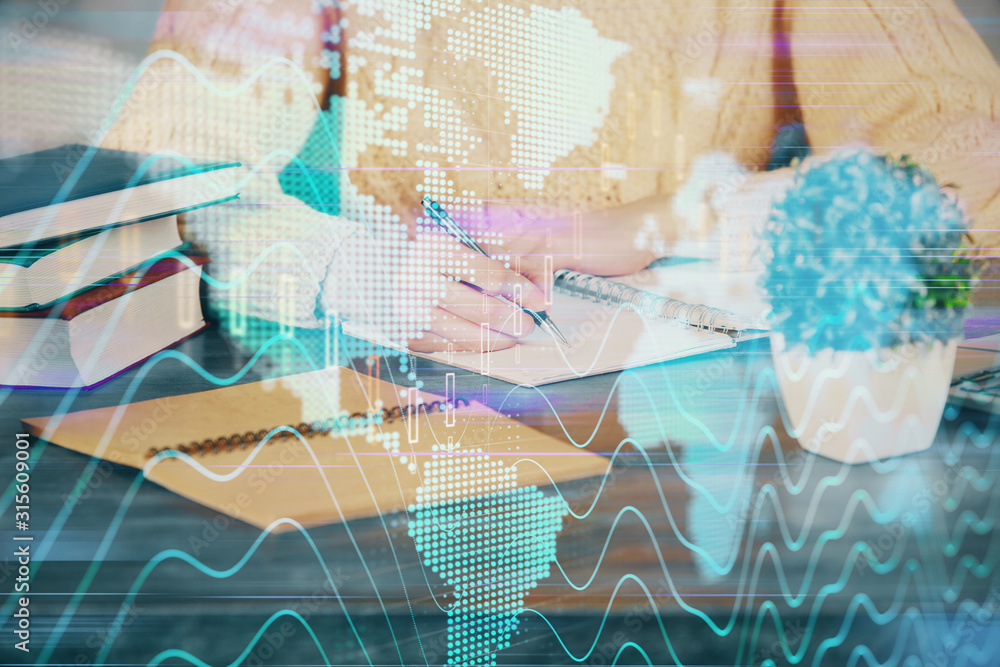 Forex graph on hand taking notes background. Concept of research. Double exposure Forex graph on hand taking notes background. Concept of research. Double exposure