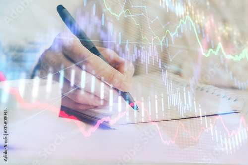 Forex chart displayed on woman's hand taking notes background. Concept of research. Double exposure