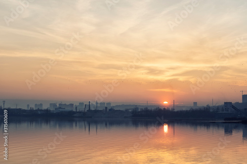 Sunset over an industrial city © rrudenkois