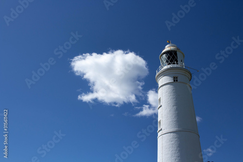 lighthouse on background of blue sky