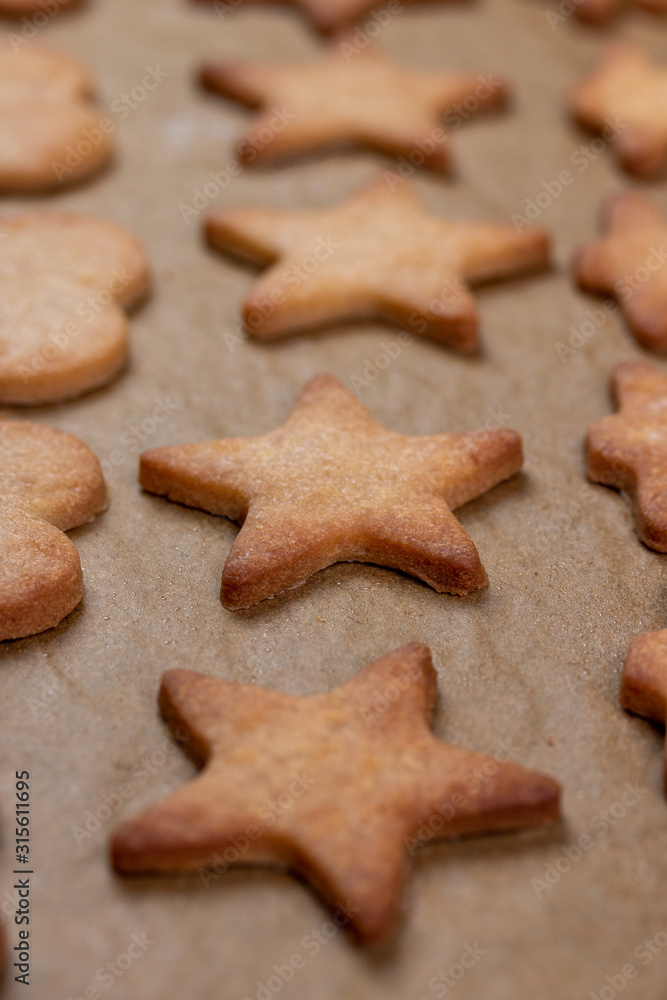 Rolled dough on a kitchen counter with cut out shapes while baking cookies or biscuits Rolled dough on a kitchen counter with cut out shapes while baking cookies or biscuits