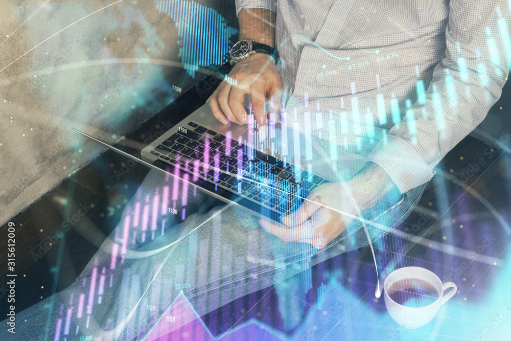 Fototapeta premium Forex graph with businessman working on computer in office on background. Concept of analysis. Double exposure.