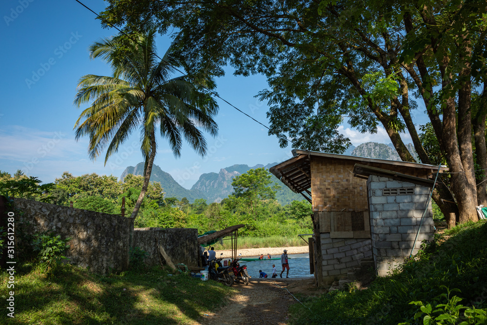 Village and mountain in Vang Vieng, Laos and Nam Song rive , Laos. Southeast Asia. Village and mountain in Vang Vieng, Laos and Nam Song rive , Laos. Southeast Asia.