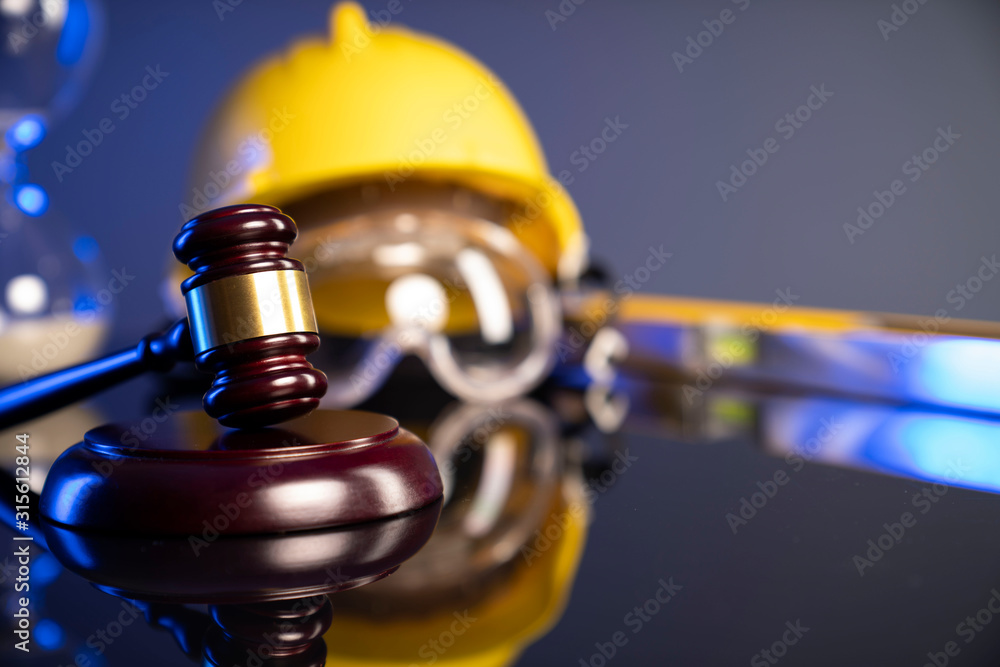 Construction law. Helmet and gavel on the blue background. Construction law. Helmet and gavel on the blue background.