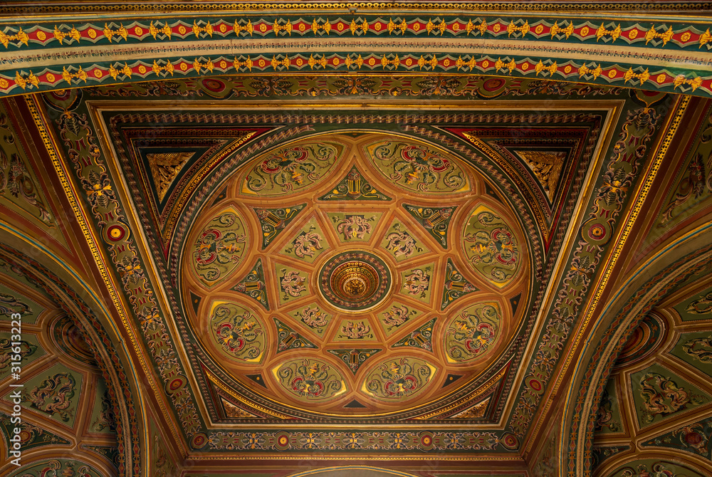 Ceiling at royal era historic Manasterly Palace decorated with colorful and golden floral paintings, Cairo, Egypt