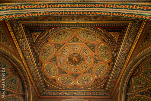 Ceiling at royal era historic Manasterly Palace decorated with colorful and golden floral paintings, Cairo, Egypt