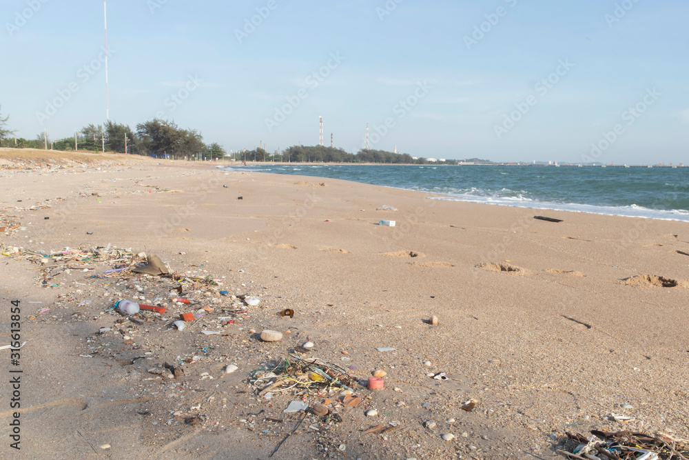 Plastic debris on the sand caused by human activities That is an environmental problem Plastic debris on the sand caused by human activities That is an environmental problem
