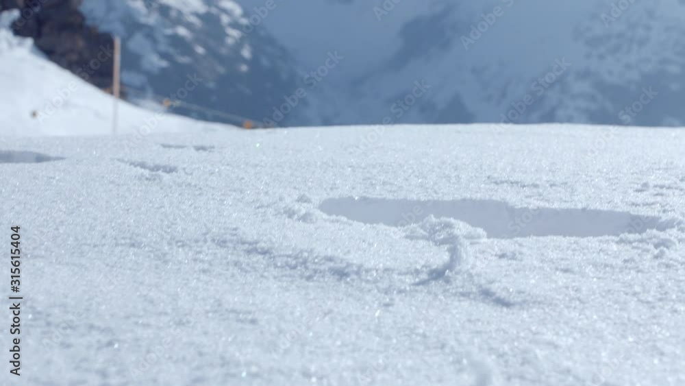 Close up of boots walking in the deep white snow in the mountains. Close up of boots walking in the deep white snow in the mountains.