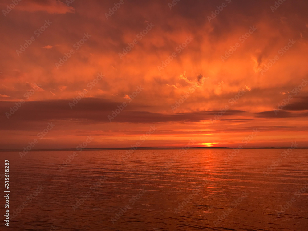 Red orange fire sunset at the sea