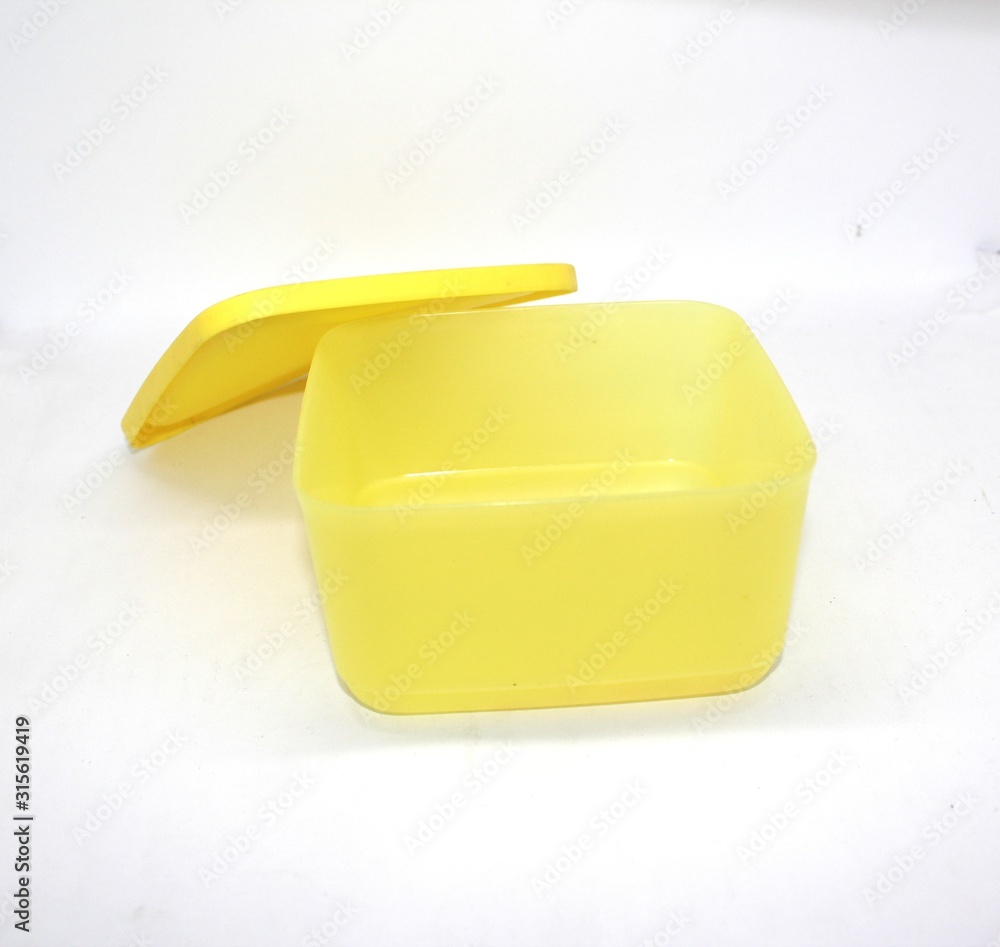 a small yellow plastic container for food isolated on white background a small yellow plastic container for food isolated on white background