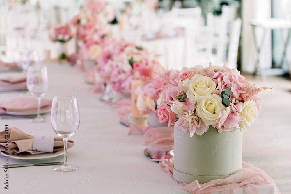 Table decor with flowers for a wedding party. Table decor with flowers for a wedding party.