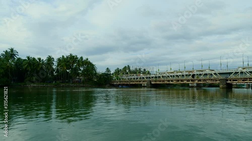 Point of view shot   of river bank and traffic on the bridge in a town, Kerala, India photo