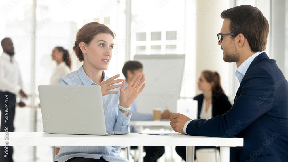 Diverse millennial employees talk discussing business ideas together Diverse millennial employees talk discussing business ideas together