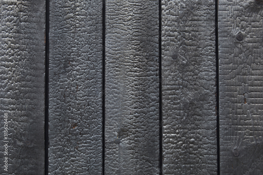 Obraz premium Czarne spalone deski z ciekawą teksturą