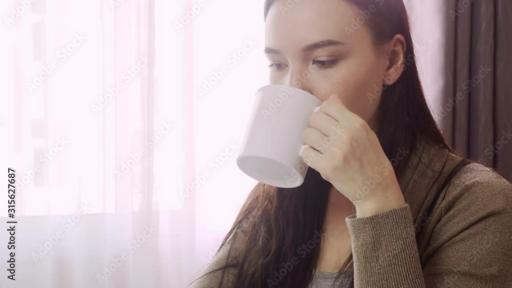 Young girl student at home schooling. She sits at a table and transcribes an essay online. Young girl student at home schooling. She sits at a table and transcribes an essay online.
