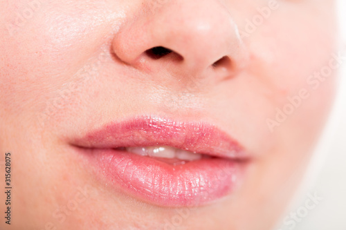 Close-up of woman s lips with natural lipstick make up. macro lipgloss make-up