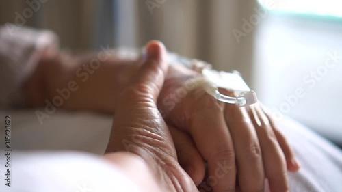 Asian Couple women hold hands lover that sick lying in Hospital bed with love emotional in Encouragement comforting, Hopeful love care emotional Recovering from family healthy slow motion