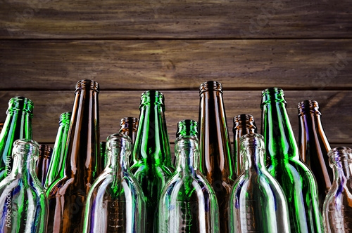 Empty and clean glass bottles on a dark wooden background