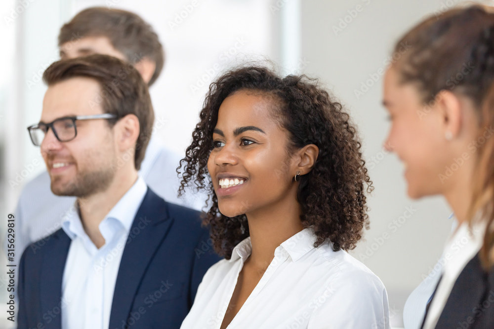 Multiethnic smiling team stand in row making group picture Multiethnic smiling team stand in row making group picture