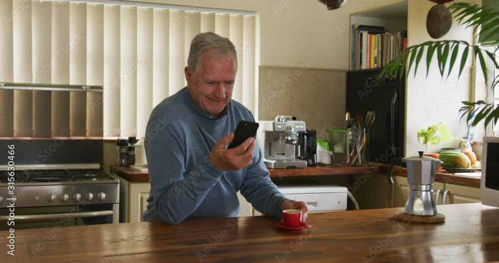 Senior man using mobile phone at home Senior man using mobile phone at home