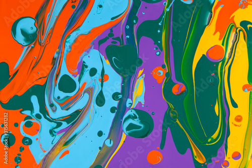 Colored acrylic paints mixed together for an abstract background.