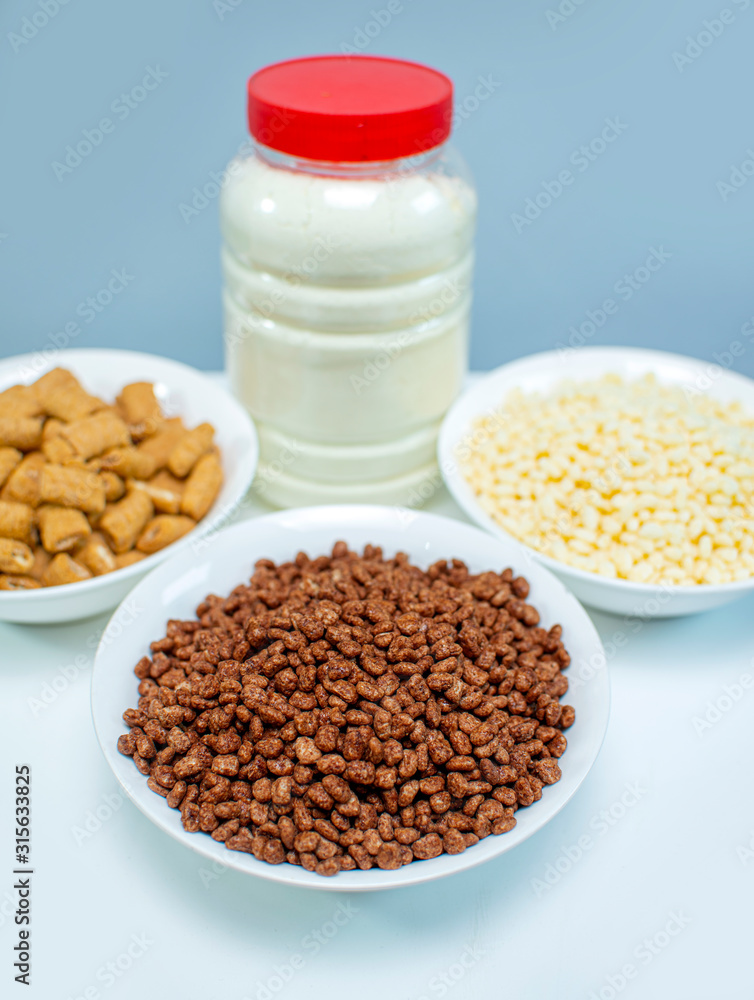 Nutrition Breakfast Concept with Cereals and Powder milk in a bowl Nutrition Breakfast Concept with Cereals and Powder milk in a bowl
