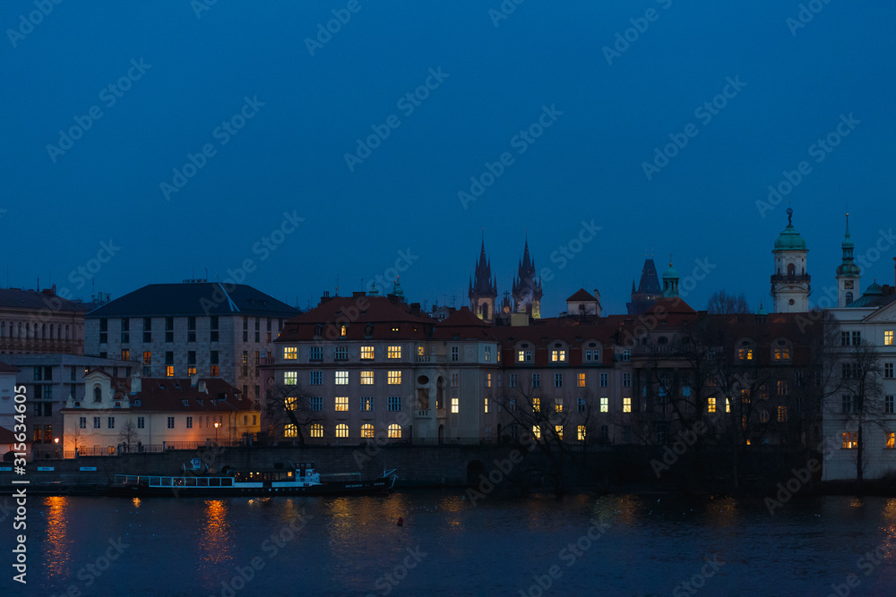 Night panorama of Prague, the capital of the Czech Republic, the lights of the night medieval city and the Vltava river and beautiful Czech houses, as a vivid example of Gothic architecture