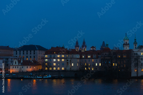 Night panorama of Prague, the capital of the Czech Republic, the lights of the night medieval city and the Vltava river and beautiful Czech houses, as a vivid example of Gothic architecture