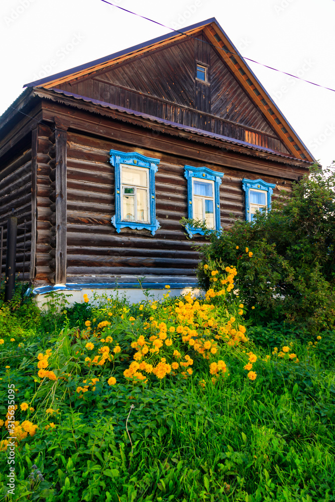 Old wooden log house in a russian village