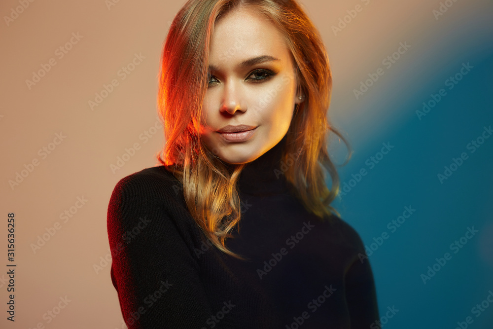 Beautiful young woman in color lights. beautiful girl