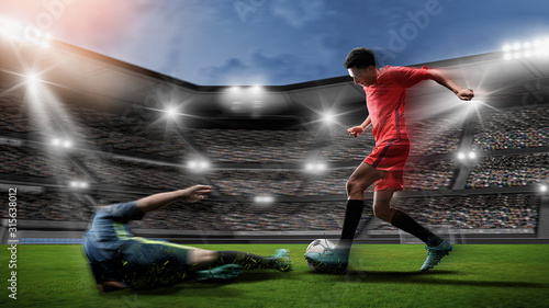 Soccer player kicks the ball on the soccer field.Professional soccer player in action. © sutadimages