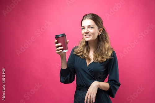 Glamor woman with a drink of coffee on a pink background. 