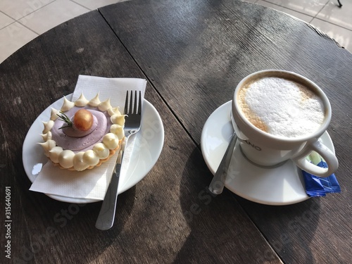 Sweet cake with cappuccino special cookies and extravagant peace and sugar round and extremely special and delicious and unhealthy food