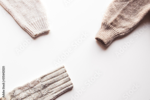 Warm knitted sleeve from a sweater with a pattern. Isolate on white.
