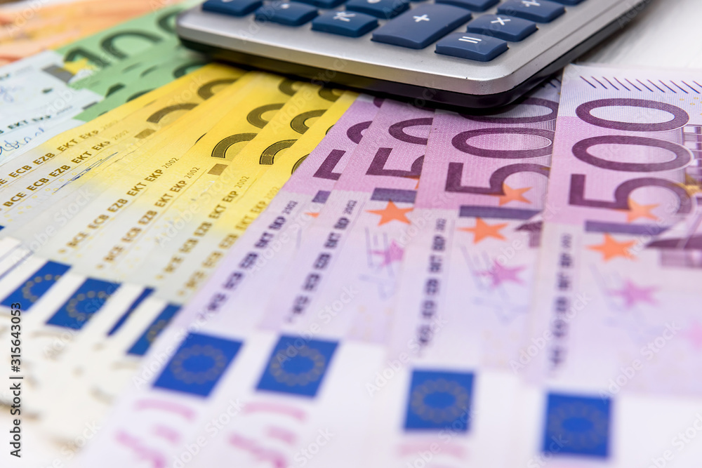 Euro banknotes on table with calculator close up