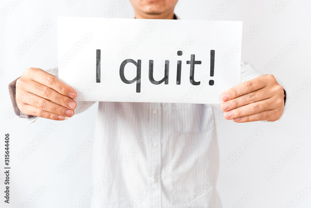 Studio shot Asian male hand showing paper with I Quit text concept Studio shot Asian male hand showing paper with I Quit text concept