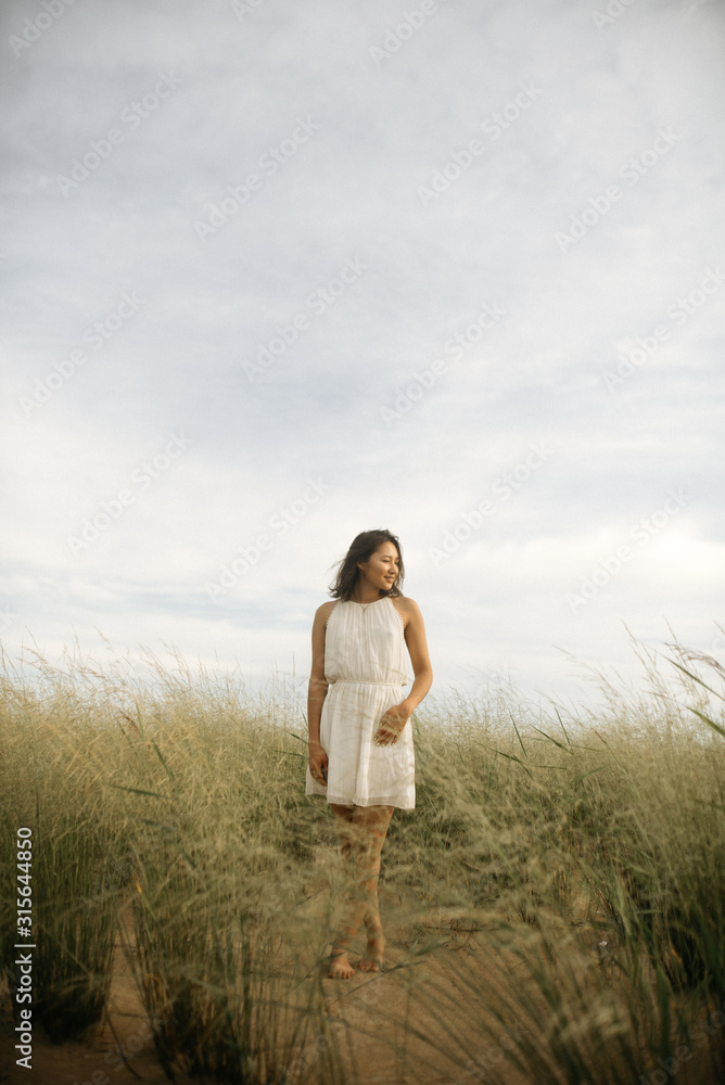 Woman in white dress on beach Woman in white dress on beach