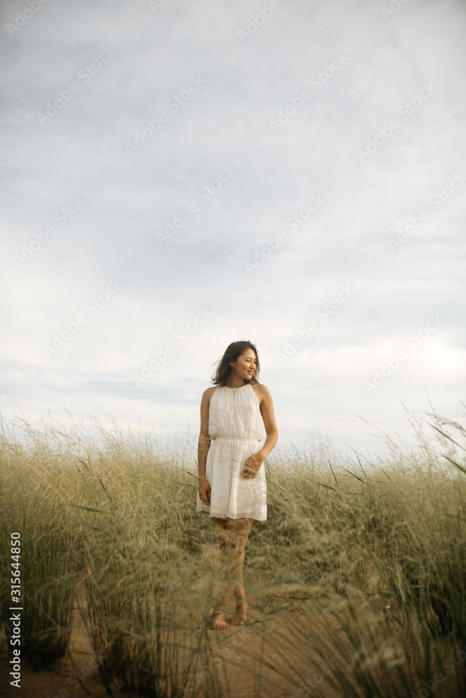 Woman in white dress on beach