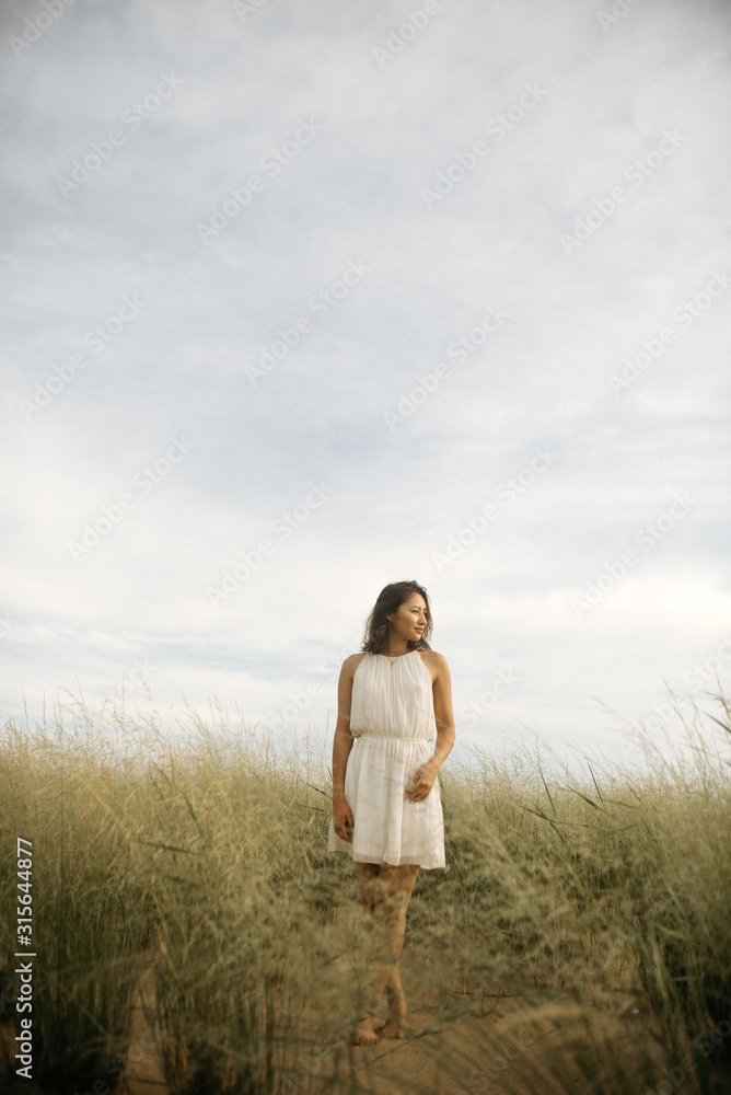 Woman in white dress on beach