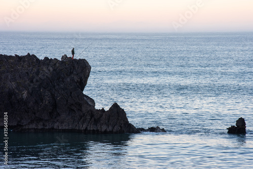 fisherman on clifftop