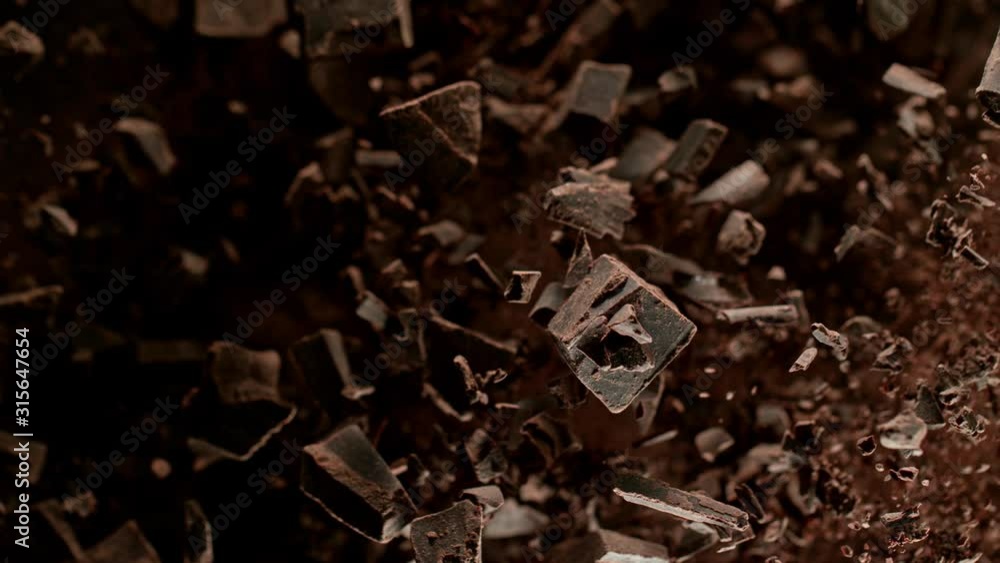 Super Slow Motion Shot of Raw Chocolate Chunks after Being Exploded Towards The Camera at 1000fps. Super Slow Motion Shot of Raw Chocolate Chunks after Being Exploded Towards The Camera at 1000fps.