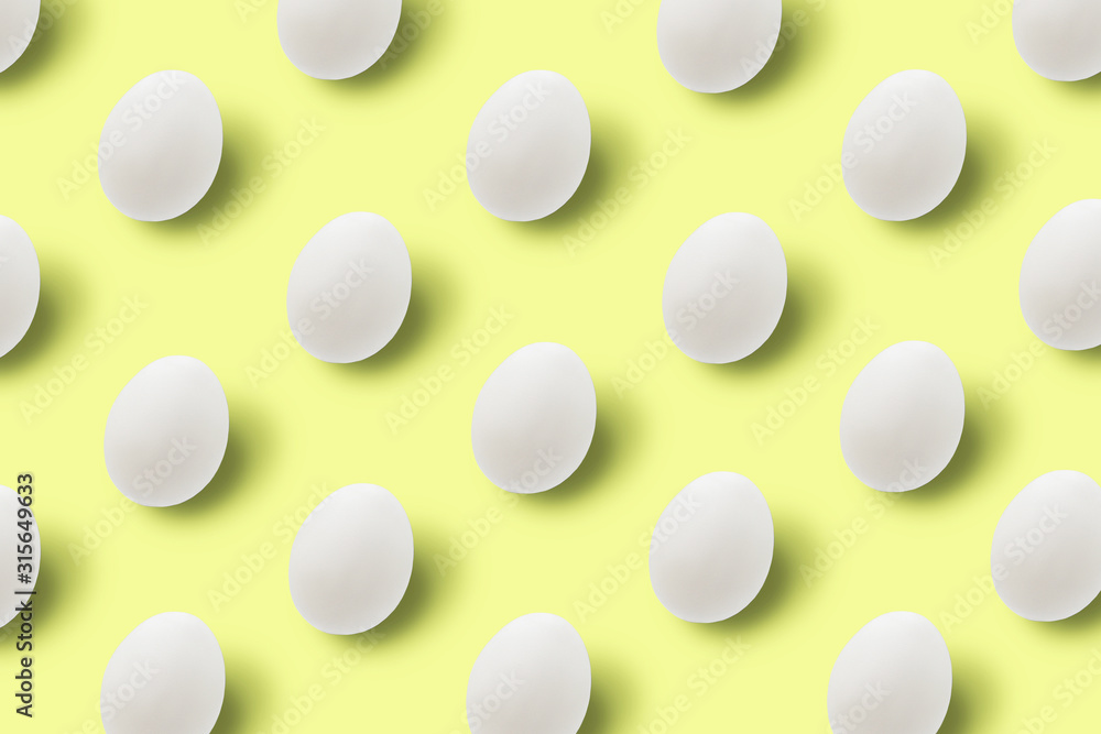 Easter white eggs on yellow background.