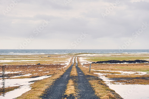Dirt road to nowhere in icelandic landscape. Path to ocean. Snaefellsnes peninsula (region of Vesturland, Iceland)