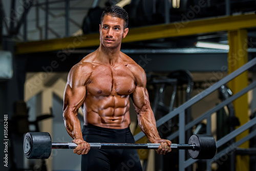 Fototapeta Naklejka Na Ścianę i Meble -  Muscular Men, Bodybuilder Lifting Weights in the Gym