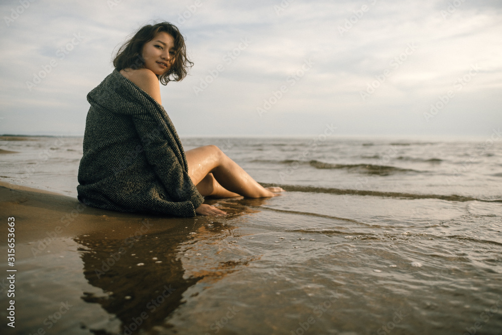 © Nikita - Woman portrait in coat on sea beach © Nikita - Woman portrait in coat on sea beach