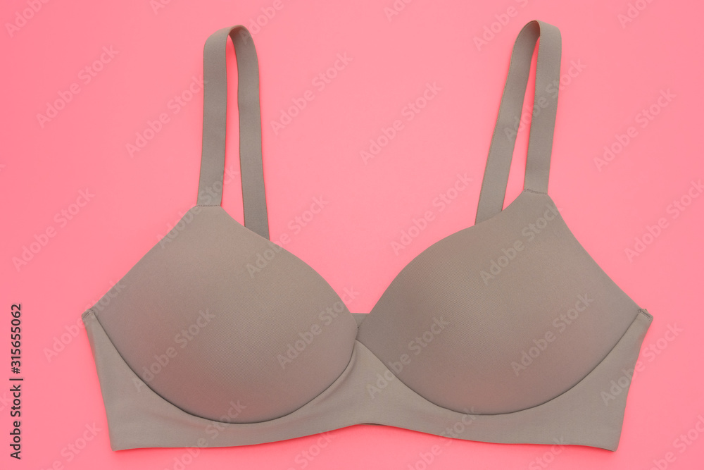 beige bra for women on a pink background beige bra for women on a pink background