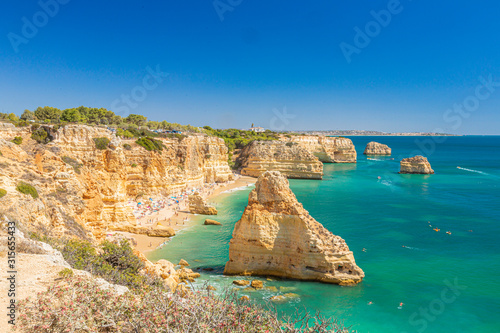 View on typical cliffy beach at Algarve coastline in Portugal in summer