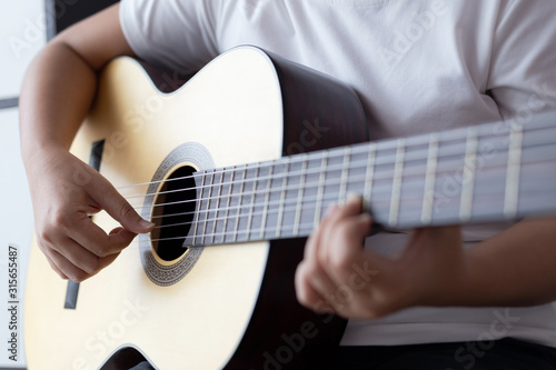 Woman hands playing acoustic classic guitar the musician of jazz and easy listening style select focus shallow depth of field