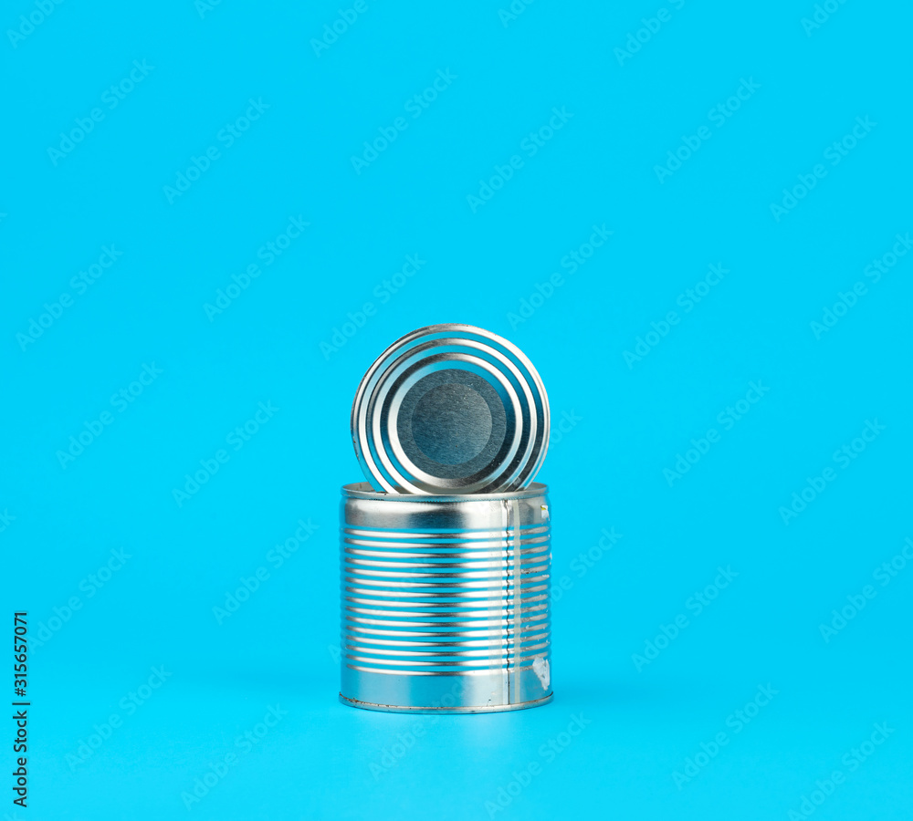 open hard iron can for food preservation on a blue background, open hard iron can for food preservation on a blue background,