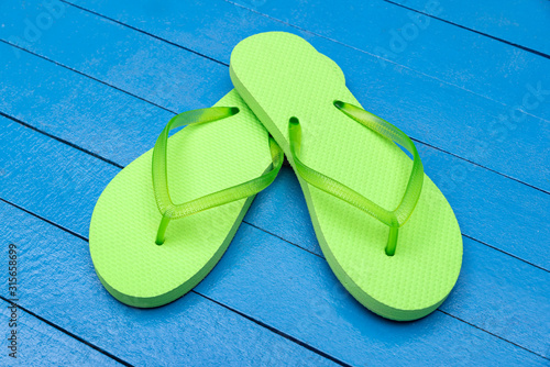 flip flops on wooden blue table photo